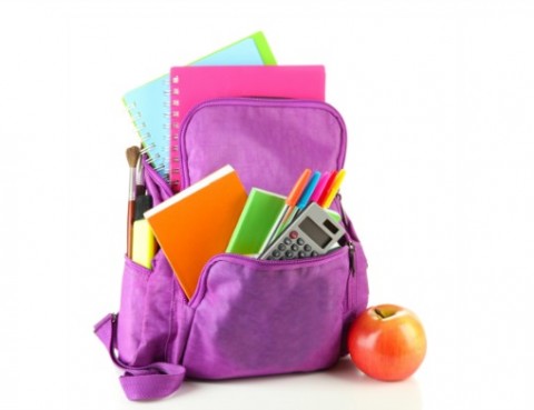 A school backpack full of folders, pins and notebooks